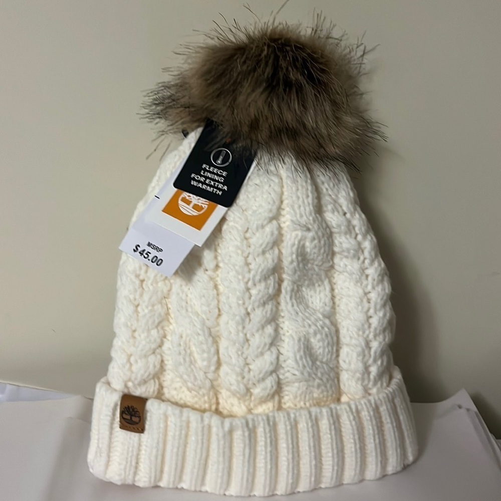 Timberland ivory cable knit, fleece lined hat with furry Pom on top, new